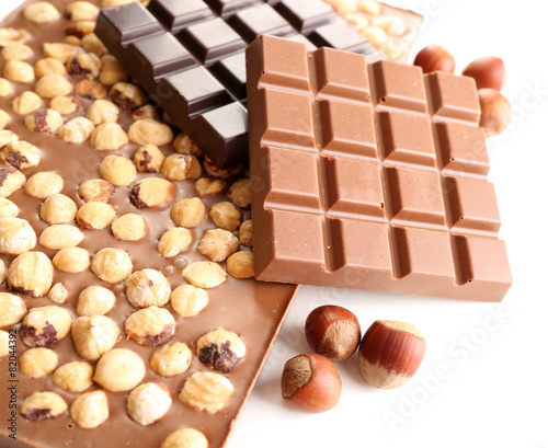 Black and milk chocolate bars with hazelnuts isolated on white