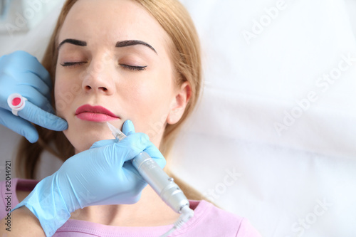 Cosmetologist applying perm...