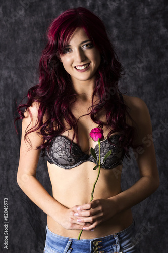 Beautiful redhead with red rose