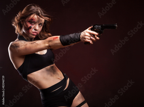 Woman warrior posing with knife. Ready to fight. With dirty face