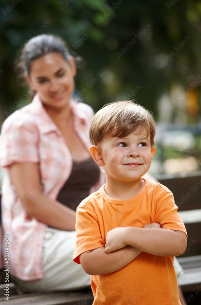 Little kid with mom standing arms crossed Little kid with mom standing arms crossed