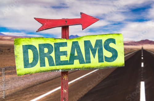Dreams sign with road background photo