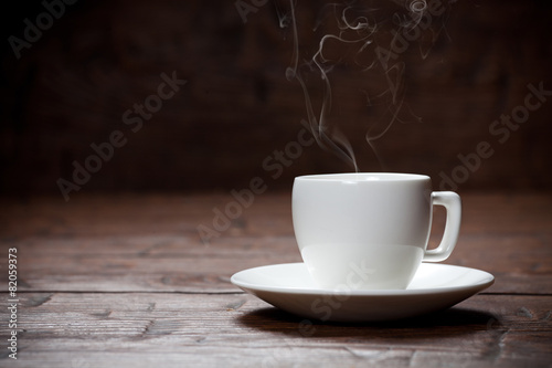 Coffee cup and saucer on old wooden table.