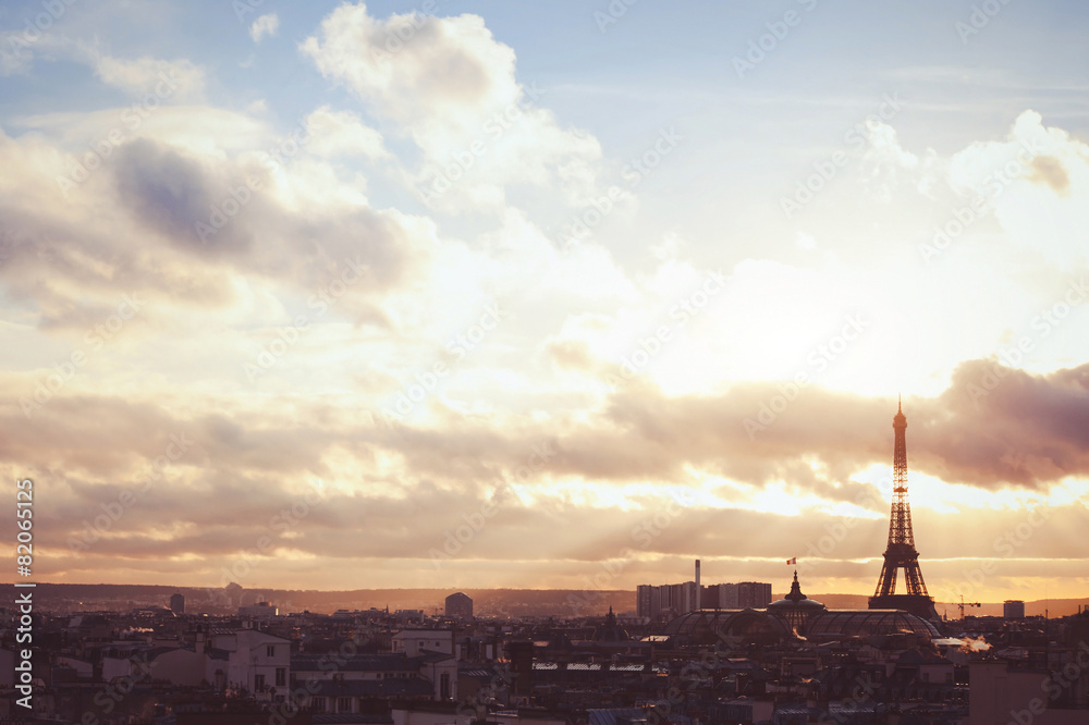 sunset sky over Paris, beautiful panoramic view with silhouette of Eiffel tower, warm colors