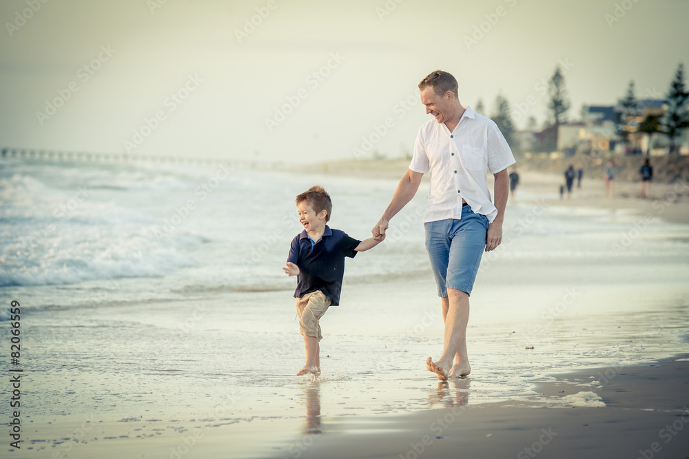 happy father and little son walking on beach parenthood concept happy father and little son walking on beach parenthood concept