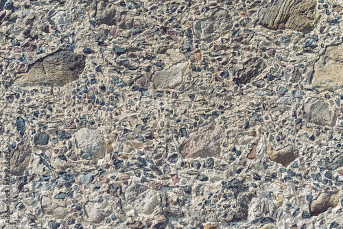 Texture of small stones on medieval wall in old building