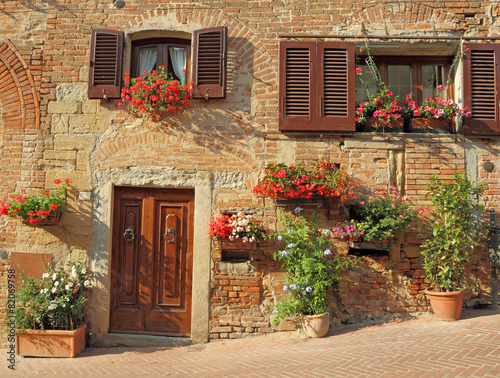 beautiful doorway to the tuscan house decorated  flowers