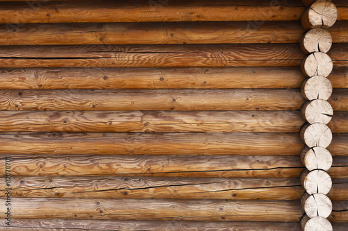 part of the wall made of wooden logs photo