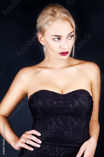 Beautiful woman on black classical dress pose