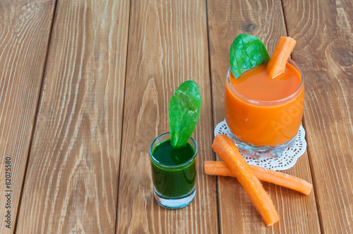 Healthy homemade carrot juice in glass and fresh carrot, spinach