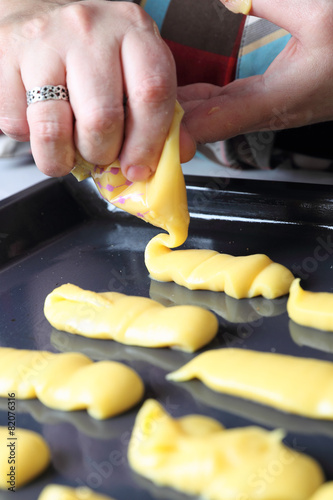 Woman squeezing dough for eclair cookies