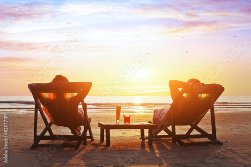 happy couple enjoy luxury sunset on the beach during summer vacations