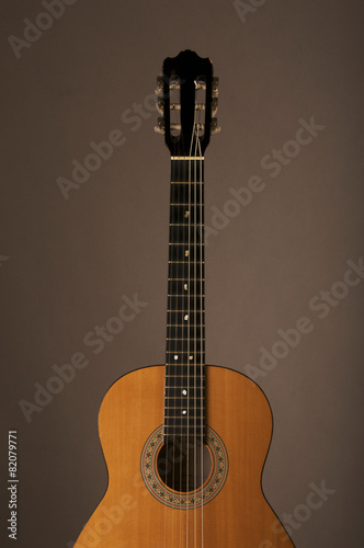 Studio detail photograph of an acoustic spanish classical guitar