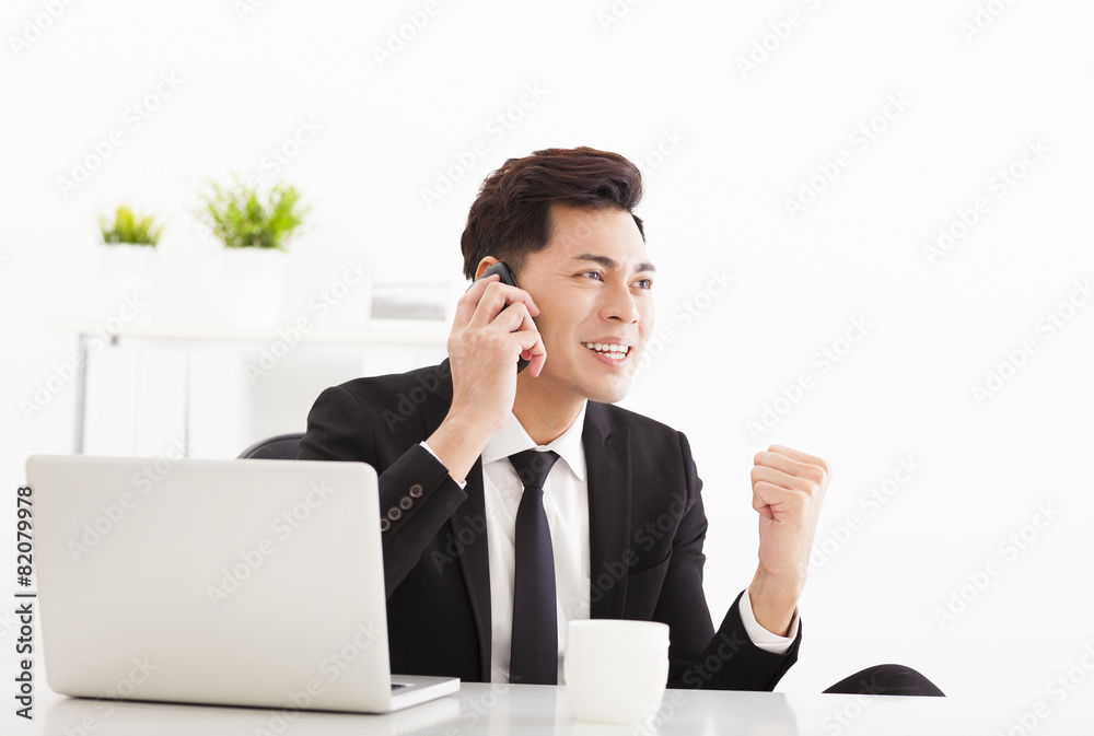 happy businessman talking on the phone in office happy businessman talking on the phone in office
