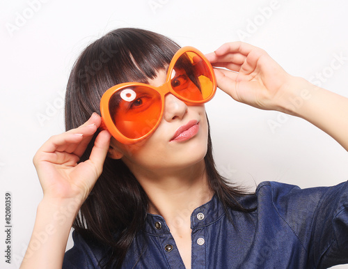 young happy woman with big orange sunglasses