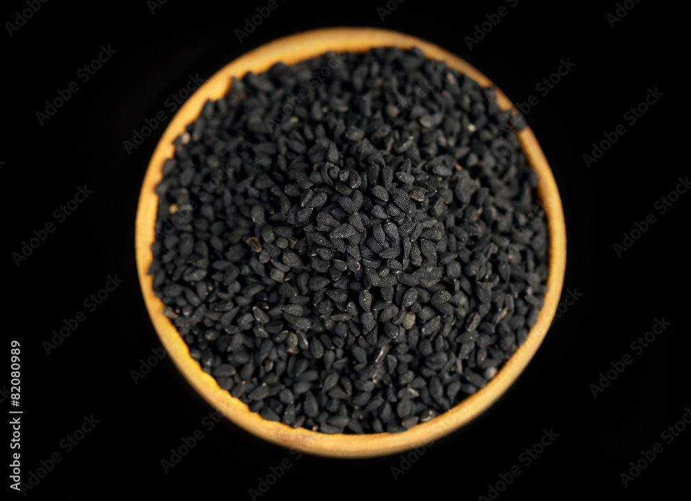 Black sesame in wooden bowl, isolated on black Black sesame in wooden bowl, isolated on black