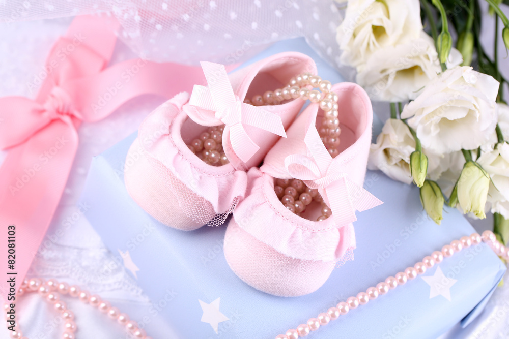 Pink baby boots with gift close-up Pink baby boots with gift close-up