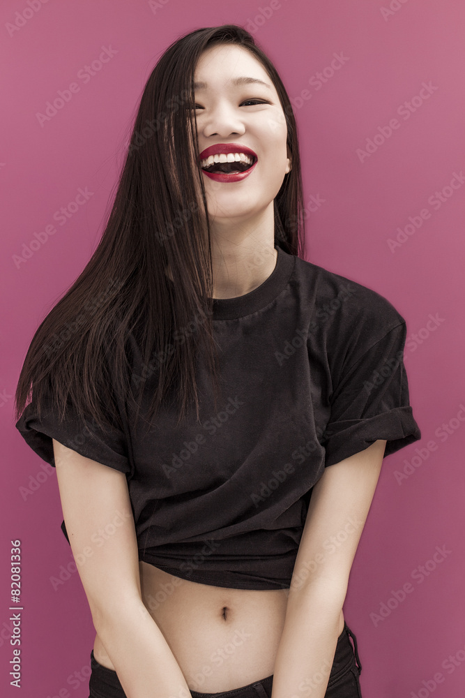 Happy chinese girl portrait on pink background Happy chinese girl portrait on pink background