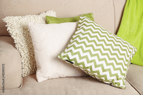 Colorful pillows on sofa close up