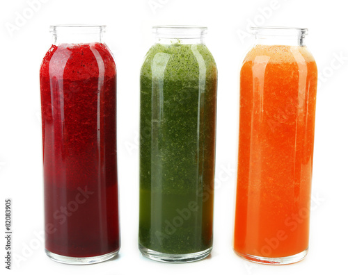 Assortment of healthy fresh juices in glass bottles, isolated