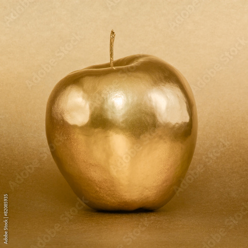 Whole golden apple on gold background