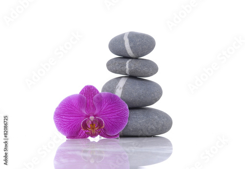 Stacked of striped stones and beautiful red orchid