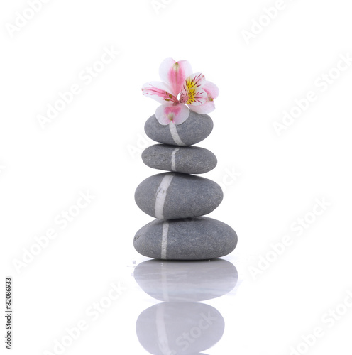 Fototapeta Naklejka Na Ścianę i Meble -  Stacked of striped stones and orchid