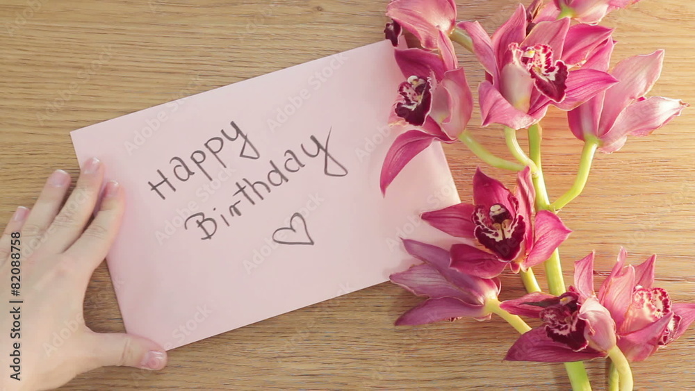 Hand put birthday card on wooden board, top view
Hand put birthday card on wooden board, top view