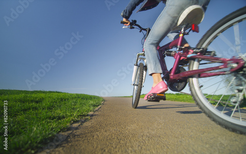 Wide angle view of a child riding a bike