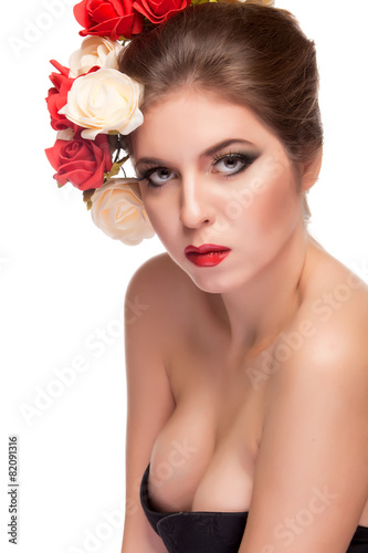 Sexy woman with flowers in hair over white background photo