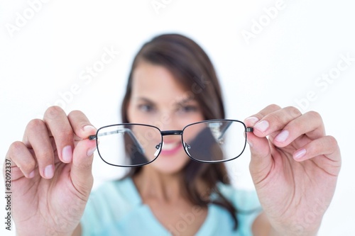 Pretty woman looking through her eyeglasses