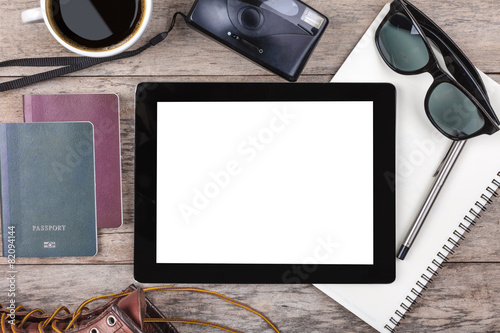 Preparation for travel,outfit, tablet ,passport, camera on woode