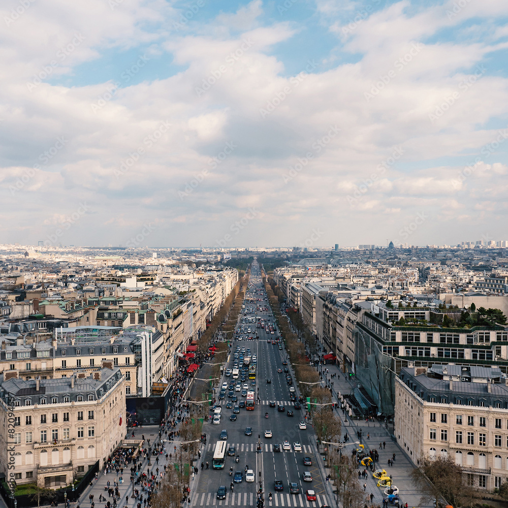 Aerial view of the city and Champs Elysees with blue cloudy sky
