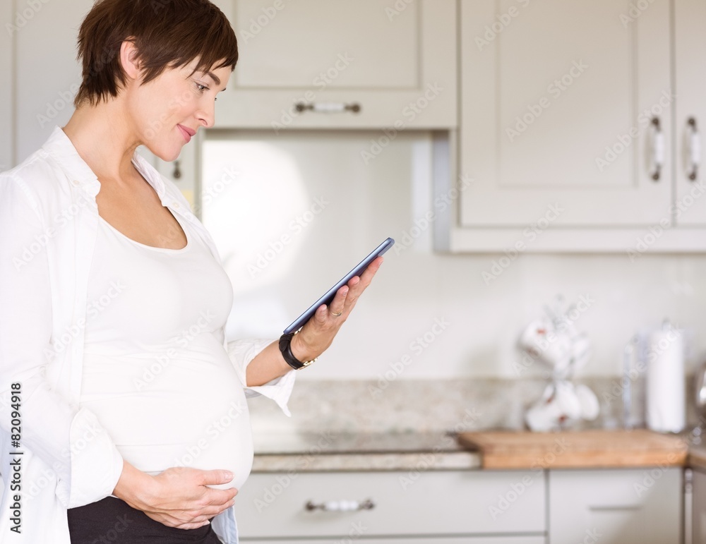 Pregnant woman using tablet pc Pregnant woman using tablet pc