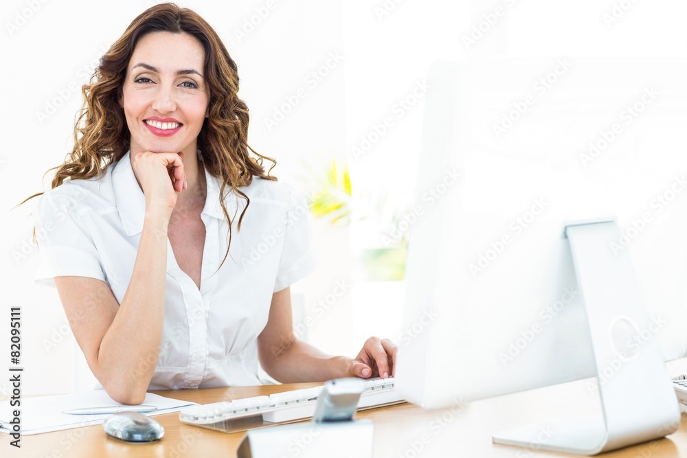 Smiling businesswoman working with her computer Smiling businesswoman working with her computer