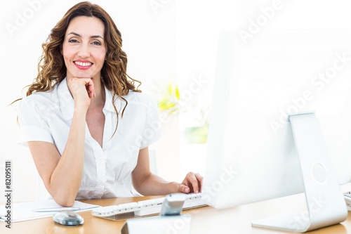 Smiling businesswoman working with her computer