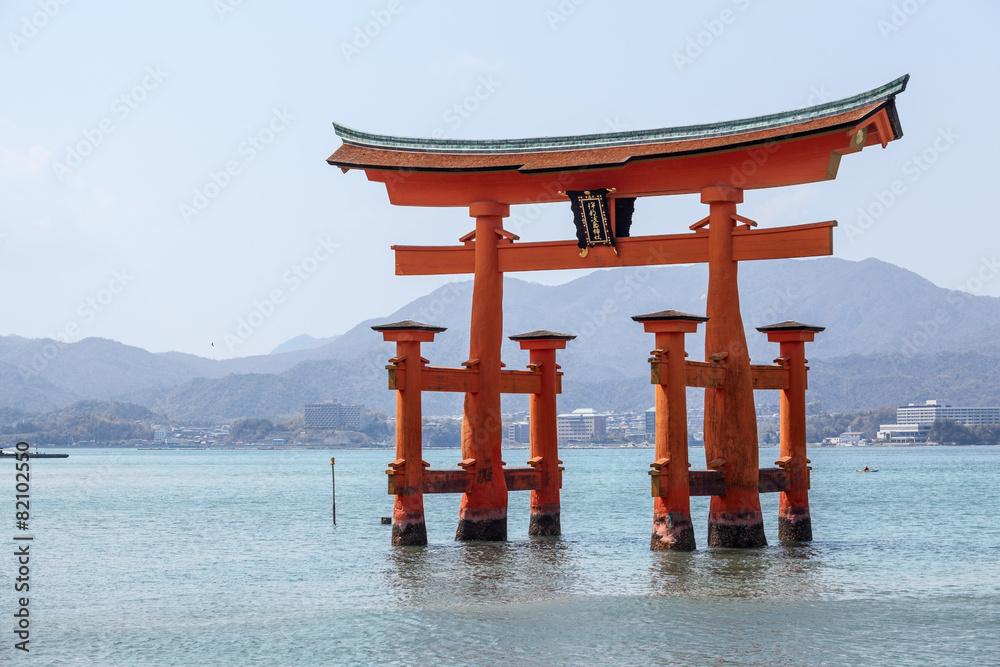 Red torii in shallow water near island of Miyajima, Japan - obrazy, fototapety, plakaty 
