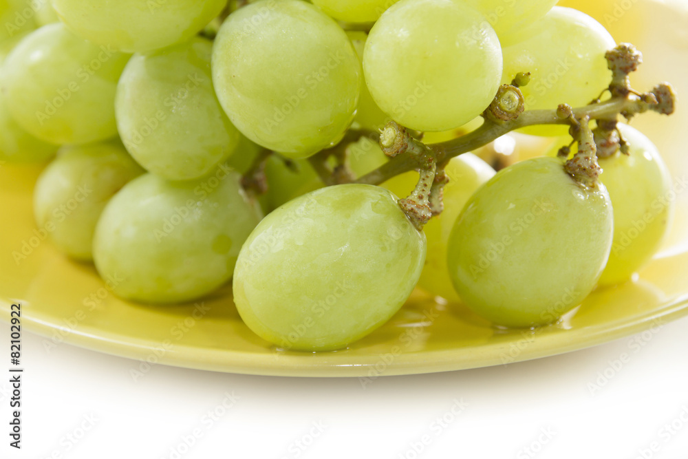 green grape consumed on yellow plate on white screen green grape consumed on yellow plate on white screen