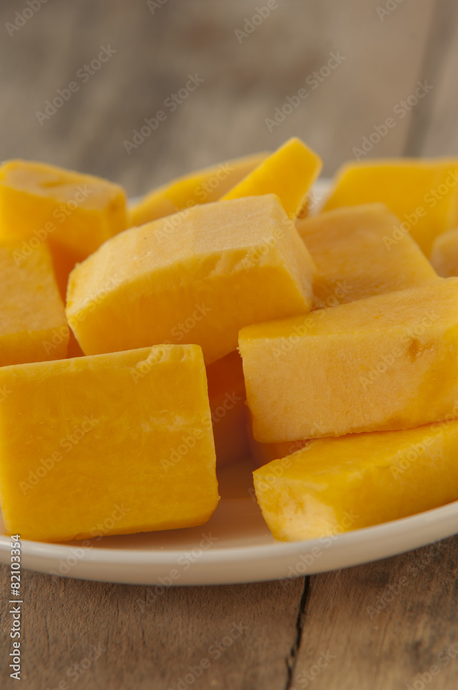 Chopped orange butternut squash on cutting board/Diced Squash Chopped orange butternut squash on cutting board/Diced Squash