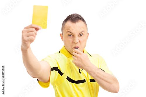 Football referee showing a yellow card