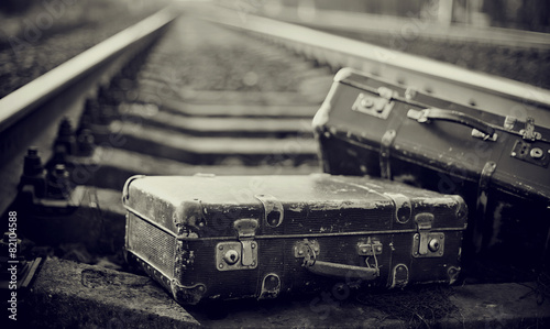 Not the color image of forgotten suitcases on rails.