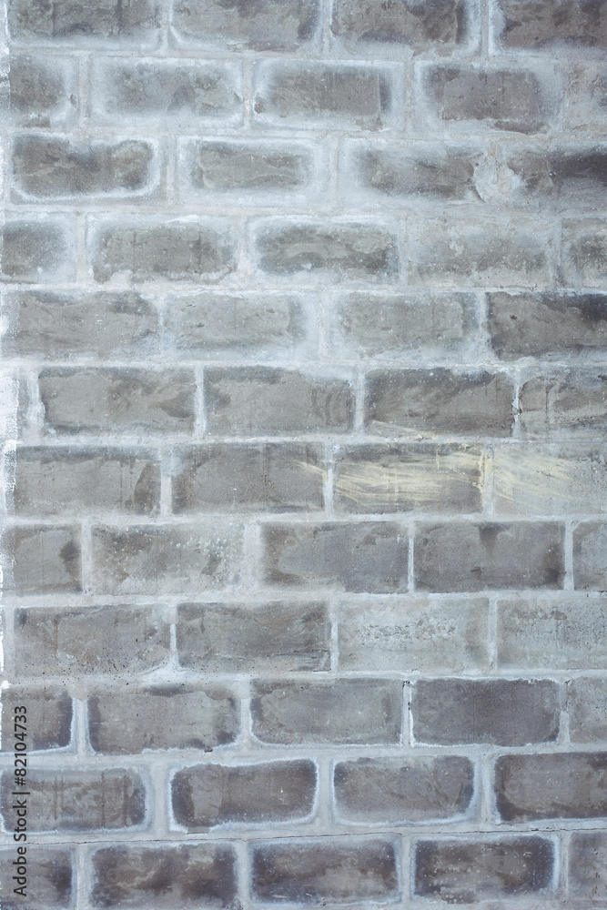 A closeup vertical image of old grey textured bricks wall. A closeup vertical image of old grey textured bricks wall.