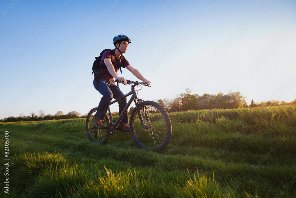 outdoor sport, young man riding bicycle in the nature