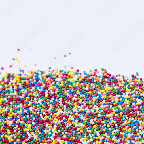 Mix of colorful Sugar balls powder background with space