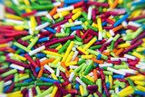 Macro of Sugar colorful sticks powder background