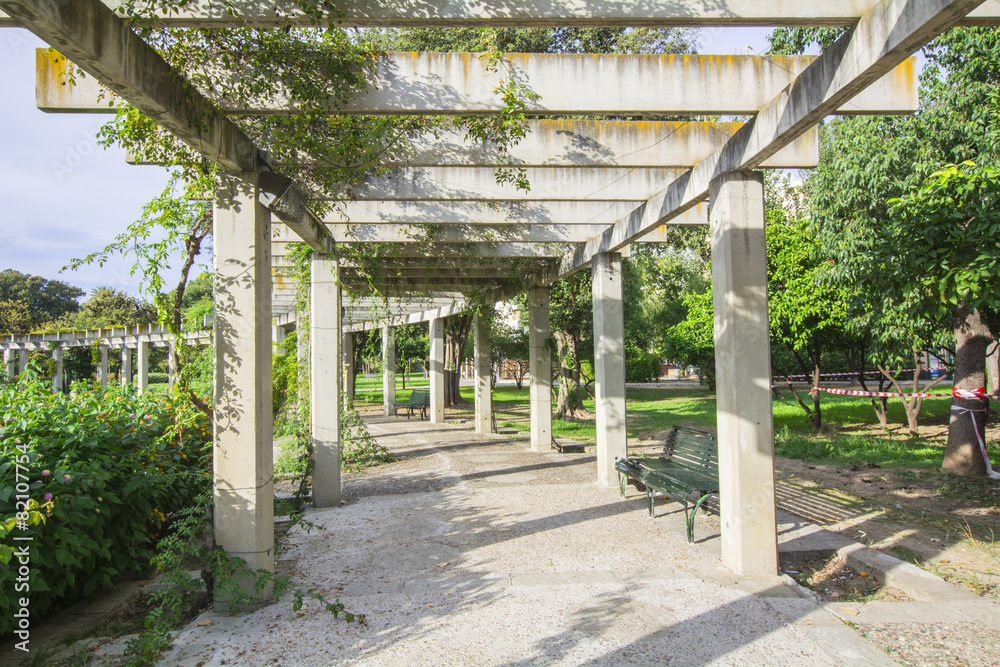 Large pergola with hanging creepers in a park Large pergola with hanging creepers in a park