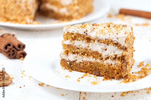 Piece of sliced gourmet carrot cake dessert with sweet cream and