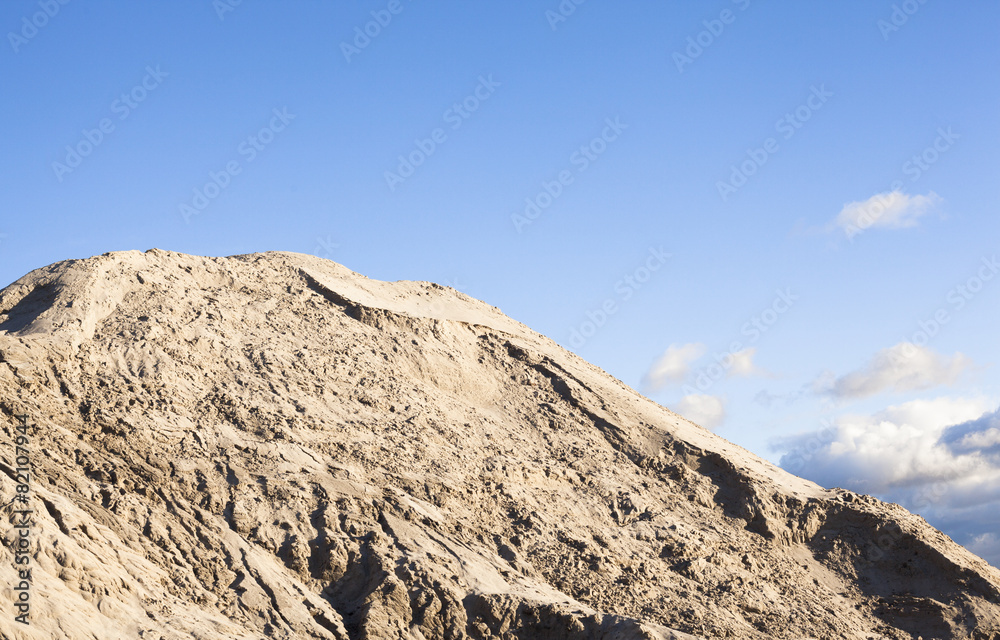 Pile of sand and blue sky over it