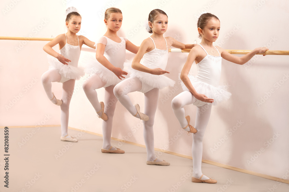 Naklejka premium Group of four little ballerinas practicing
