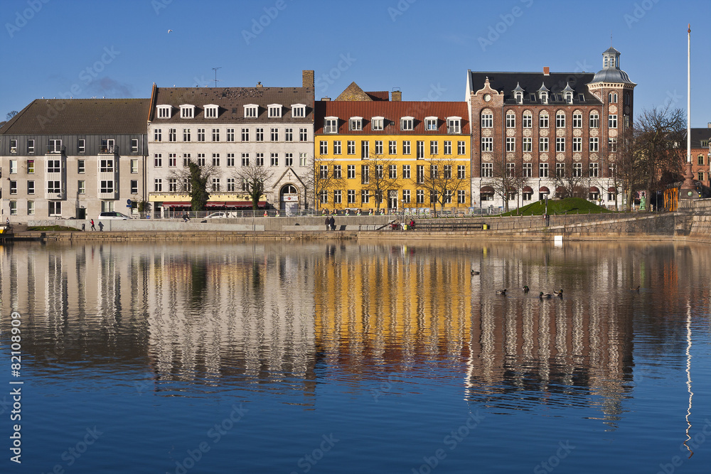 Row of Colorful Buildings on Sunny Day Reflected in Water